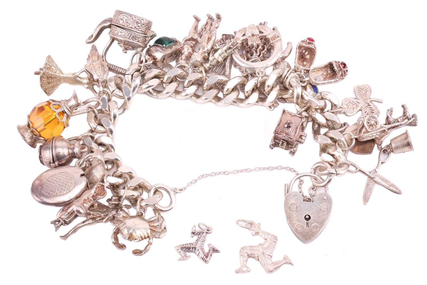 A silver charm bracelet, the silver curb chain with hallmarked heart padlock clasp, with a large