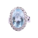 An aquamarine and diamond cluster ring, set with an aquamarine measuring 16.2mm x 10.8mm,