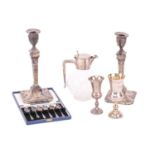 A small collection of silver comprising a silver mounted and glass claret jug, a set of six coffee