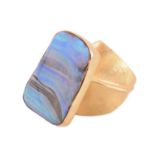 A yellow metal and boulder opal dress ring; the oblique shaped rectangular plaque within a