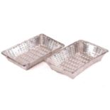 A pair of silver-plated rectangular bread baskets with tied reed rims and strap woven bodies,