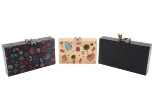 Three Charlotte Olympia 'Pandora' box clutches; the first in black perspex and dachshund clasp