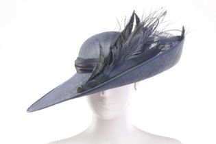 A Vivien Sheriff sinamay disc hat in navy blue, with coordinating quills on brim. Cased in the