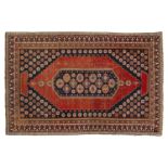 An antique Armenian Erivan rug with red ground and central lozenge the corners filled with flower