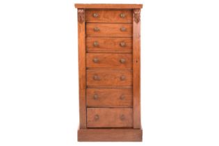 A Victorian walnut Wellington chest of seven short drawers secured with a single hinged register bar
