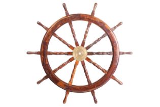 A large maritime teakwood ship's wheel with a bronze nave plate and turned handle with ten turned