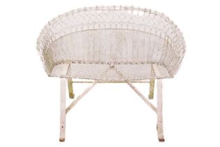 An early 20th-century French two-seat established rustic wire work conservatory seat, with scroll