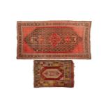 An antique black ground Malayer carpet with a central diamond motif and a field filled with boteh