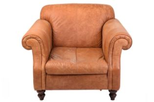 An Edwardian-style distressed tan hide oversized club armchair, twentieth century, with roll-over