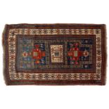 An antique Caucasian Karachov Kazak rug with abashed blue ground, with three geometric elements