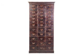 A free-standing flight of thirty-six stained wood haberdashery drawers, early 20th century, each