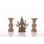 An Indian bronze seated figure of Mahadevi upon a double lotus socle, 14 cm wide x 16 cm high,