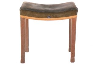 A Queen Elizabeth II limed oak coronation stool, with a concave seat with its original blue-green