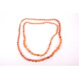 An old string of Butterscotch /Russet amber beads, 47 cm long the longer of the two, 95.3 grams