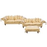 A pair of large contemporary high-quality, scroll-end modern sofas and a matching footstool, each
