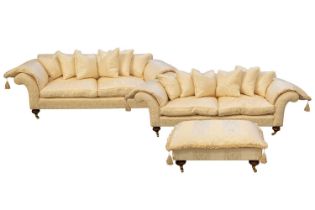 A pair of large contemporary high-quality, scroll-end modern sofas and a matching footstool, each