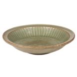 A Chinese circular celadon dish, Southern Song/Early Yuan Dynasty, with fluted cavetto and the