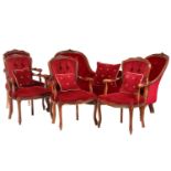 A Victorian walnut framed double chair backed settee with carved and moulded outline with crimson