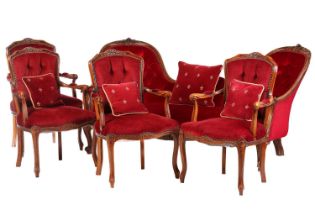 A Victorian walnut framed double chair backed settee with carved and moulded outline with crimson