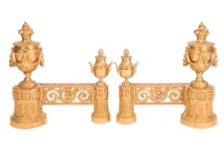 A pair of French Empire style gilt bronze chenets, each with large flaming urn draped with swags