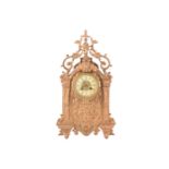 A Nineteenth-century gilt metal mantel clock, the case in the Baroque style with peacock head