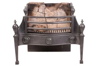 A George III-style cast iron fire grate, 20th century, with a serpentine frieze decorated with