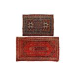 A small antique red ground Caucasian Lesghi rug with distinctive star motifs within multiple