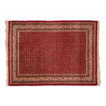 Red ground Boteh Mir rug with all over motif within a fish bone border, 215 cm x 158 cm. Some moth