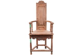 A 17th-century style and later oak caquetoire armchair, Scottish or possibly French with a scroll