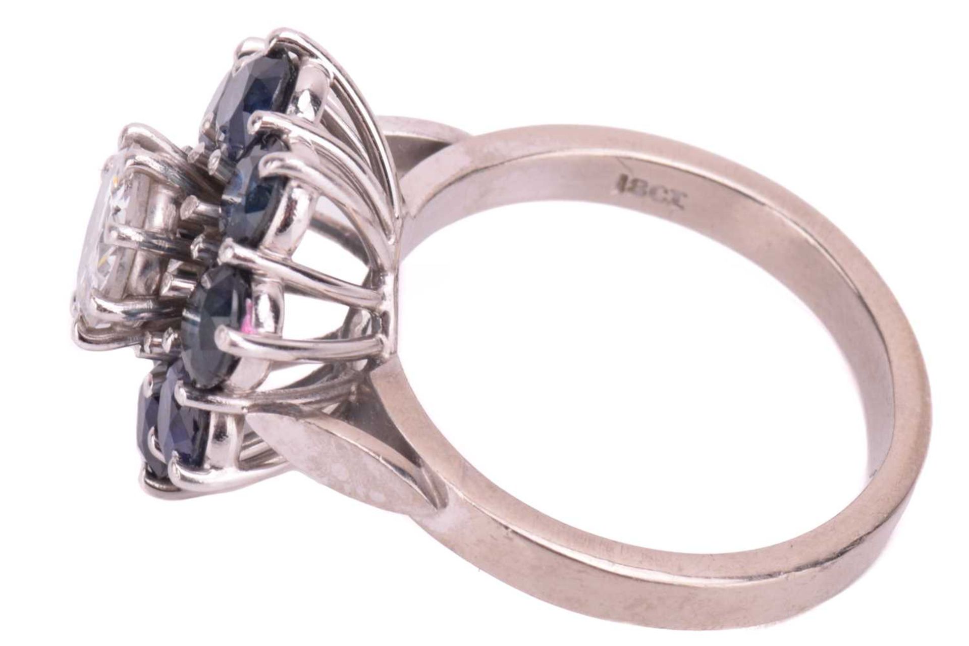 A diamond and sapphire flowerhead cluster ring, centred with a round brilliant-cut diamond of 6.2 - Image 5 of 5