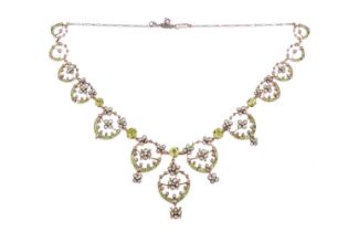 An Edwardian diamond, peridot and demantoid garnet necklace, circa 1910, the floral garland design