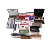 A collection of boxed pens, including various pens by different makers such as Parker, Cross,