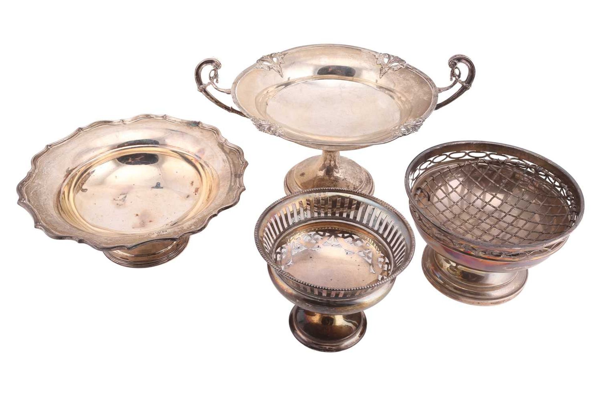 Four silver pedestal dishes; including a tazza by Elkington & Co Ltd, Birmingham 1912, with scrolled