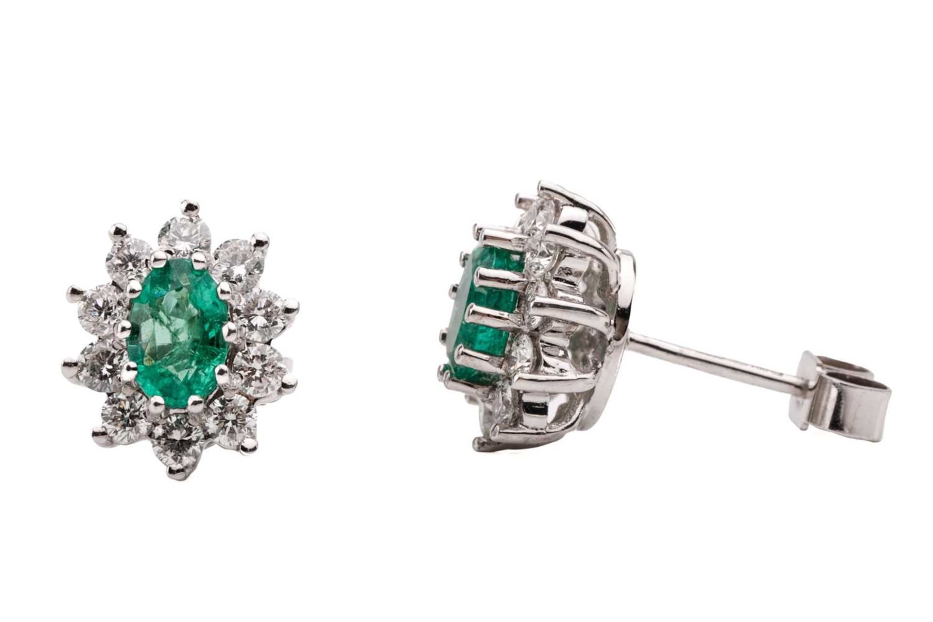 A pair of 18 carat white gold, emerald and diamond earrings; the oval cut emeralds in claw mounts - Image 3 of 3