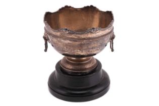 A silver rose bowl on an ebonised presentation stand, the rim cast with cherub masks, of plain round