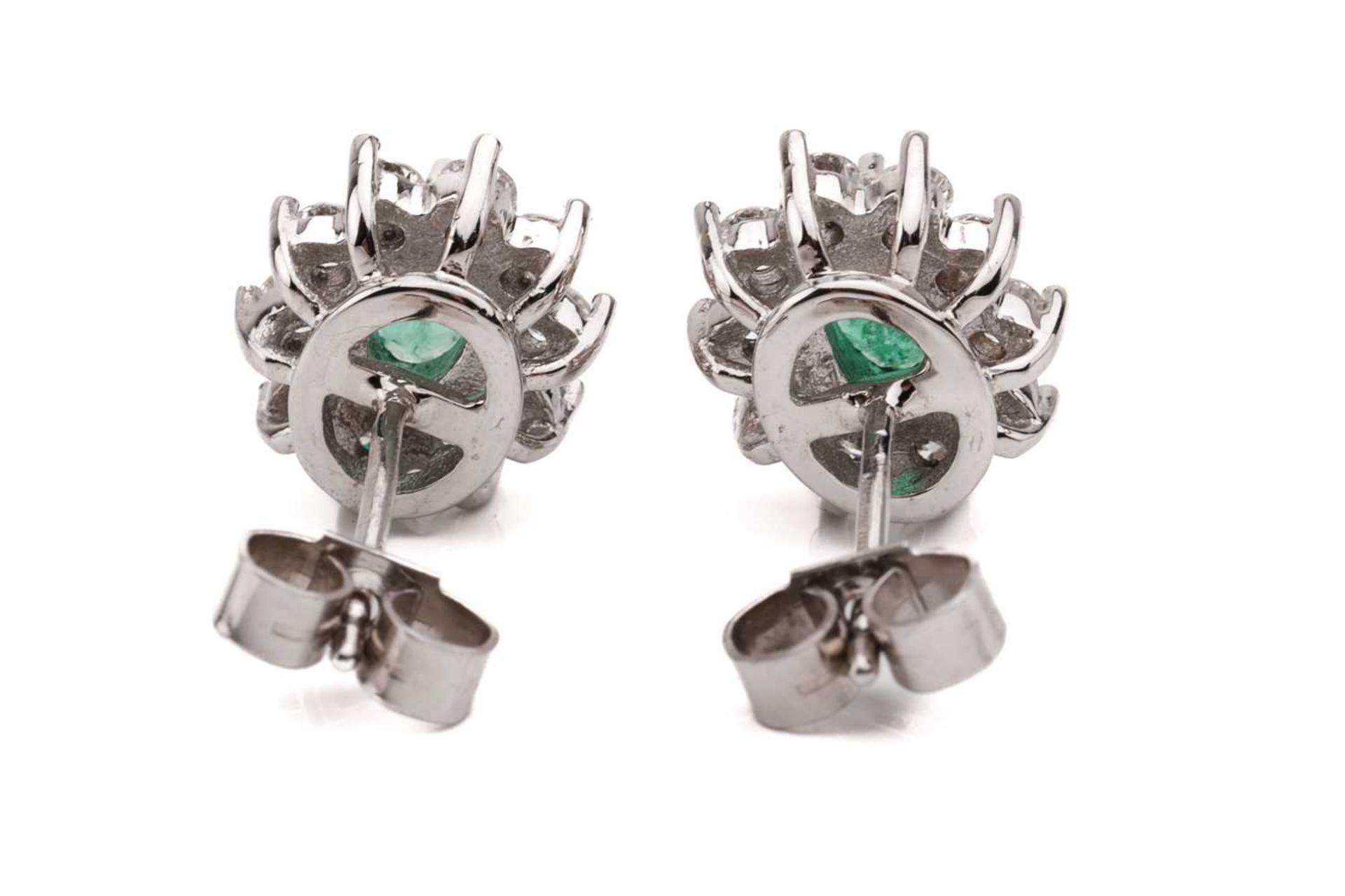 A pair of 18 carat white gold, emerald and diamond earrings; the oval cut emeralds in claw mounts - Image 2 of 3