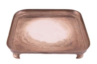 A Scottish silver salver, square with rounded corners to raised sides, on four bracket feet, Glasgow