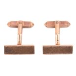 A pair of 9ct yellow gold cufflinks by Kurt Weiss, of wedge form with Florentine finish and T-bar