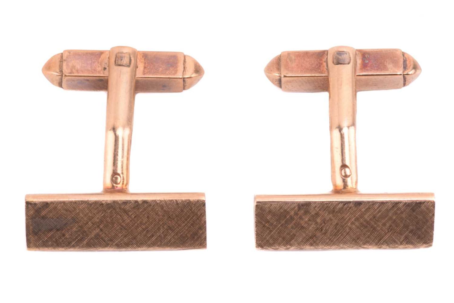 A pair of 9ct yellow gold cufflinks by Kurt Weiss, of wedge form with Florentine finish and T-bar