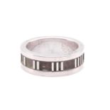 Tiffany & Co. - an 'Atlas' ring, flat band with straight edges, decorated with Roman numerals on