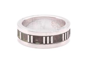 Tiffany & Co. - an 'Atlas' ring, flat band with straight edges, decorated with Roman numerals on