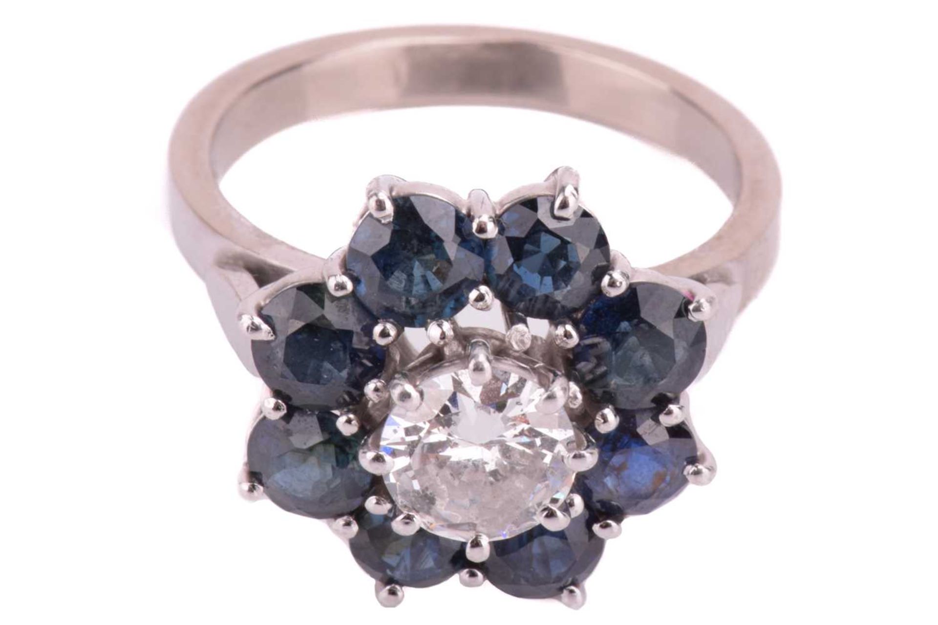 A diamond and sapphire flowerhead cluster ring, centred with a round brilliant-cut diamond of 6.2 - Image 2 of 5