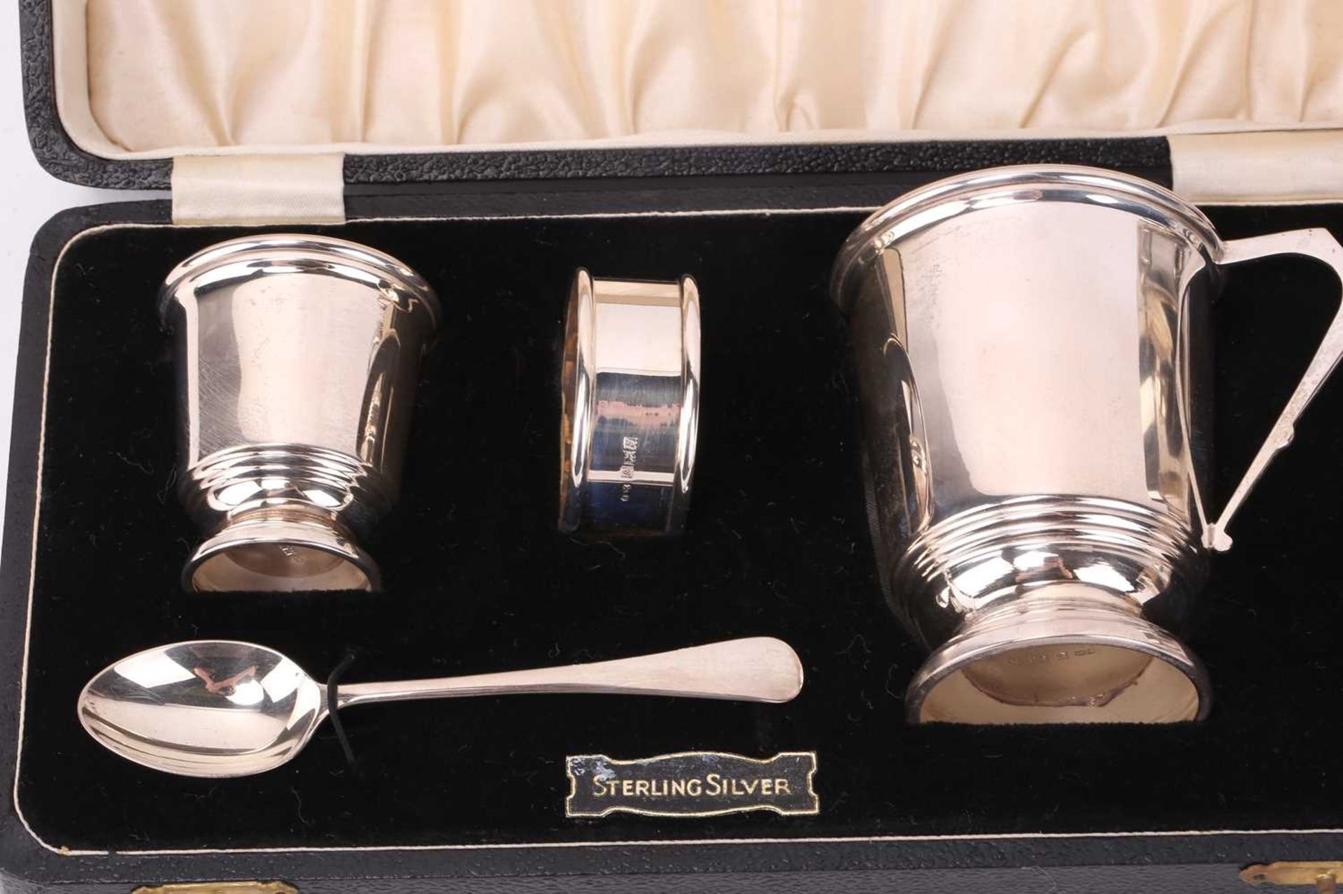 A cased silver christening set comprising a Christening mug, egg cup and spoon, napkin ring, - Image 7 of 7