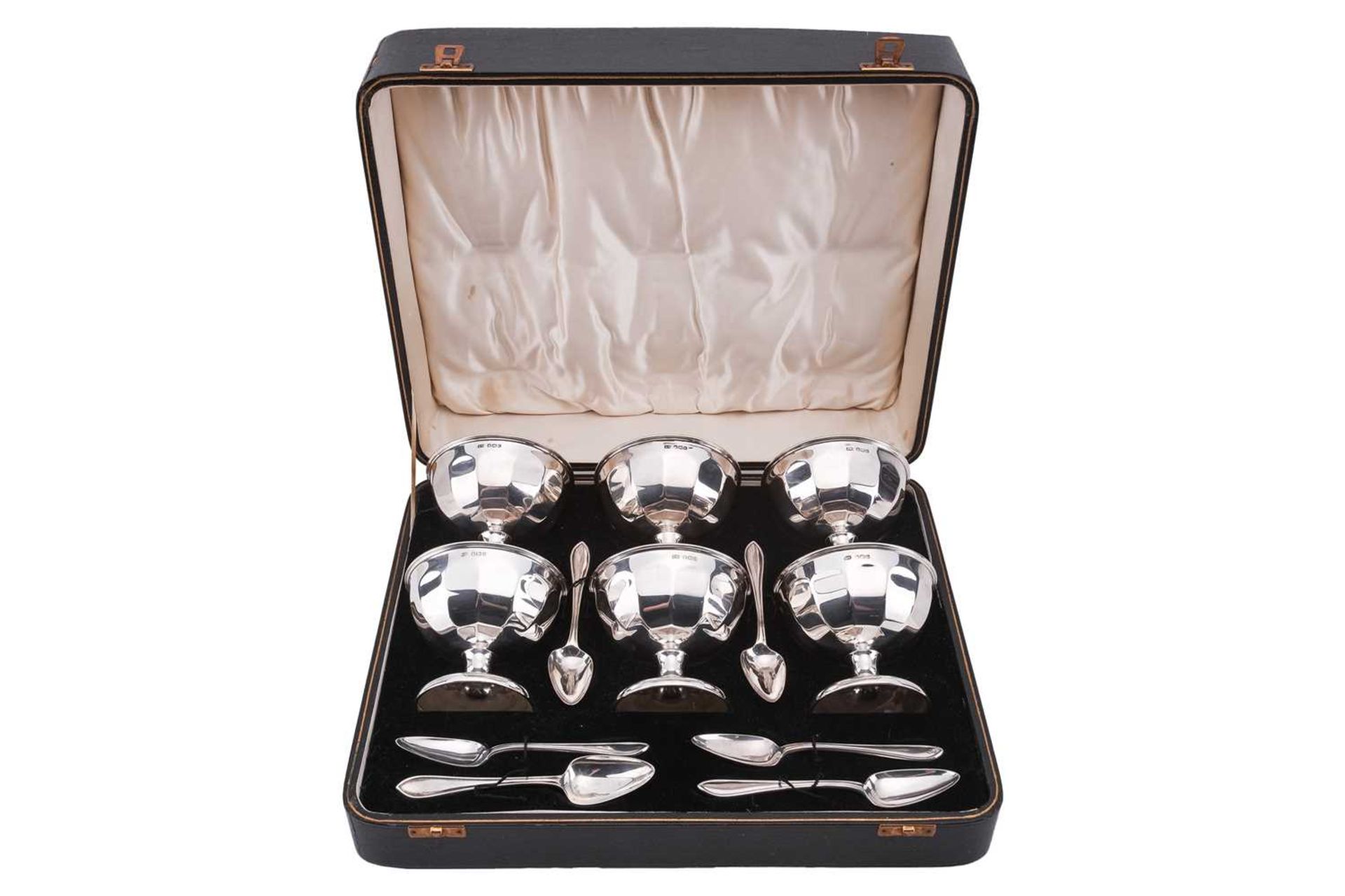 A cased silver grapefruit set; comprising six panelled bowls on spreading trumpet feet and six