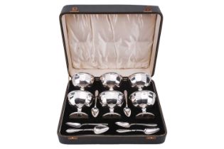 A cased silver grapefruit set; comprising six panelled bowls on spreading trumpet feet and six