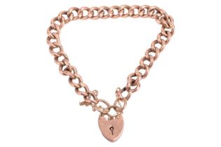 An Edwardian cable link bracelet in 9ct yellow gold, completed with a heart-shaped padlock clasp and