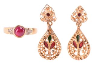 A ruby dress ring and a pair of enamel pendant earrings; the ring centred with a round ruby cabochon