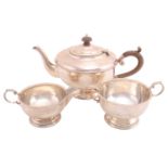 A three-piece silver tea service, Birmingham 1931 by Henry Clifford Davis, comprising a teapot, a