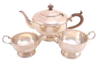 A three-piece silver tea service, Birmingham 1931 by Henry Clifford Davis, comprising a teapot, a