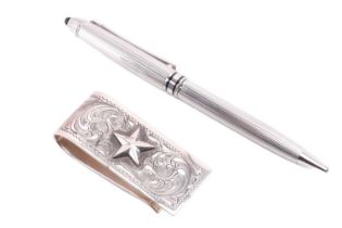 A Mikimoto ballpoint pen and a money clip; the pen with a fluted barrel and a black beaded cap,